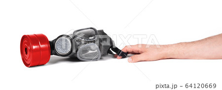 Arm reaching for vintage gasmask isolated on white Arm reaching for vintage gasmask isolated on white 64120669