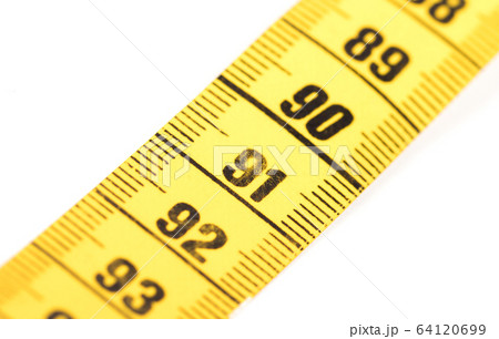 Close-up of a yellow measuring tape isolated on Close-up of a yellow measuring tape isolated on 64120699