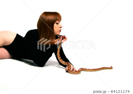 Beautiful woman in black bodywear and snake. Ginger model girl with fashion perfect make up. 64121174