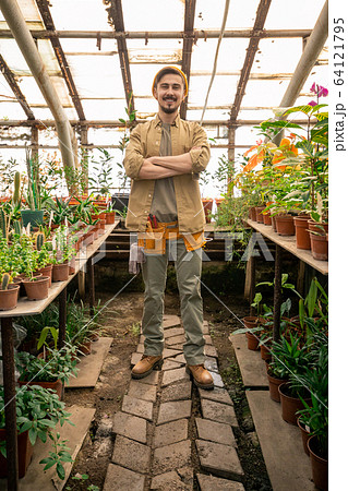 Cheerful greenhouse grower 64121795