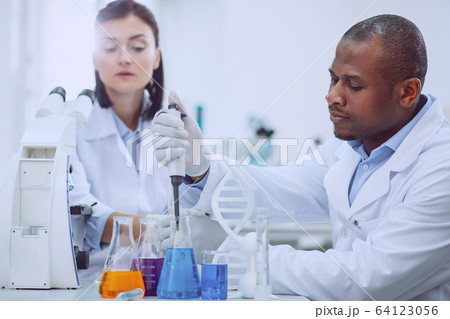 Determined scientists developing a new vaccine in the lab Determined scientists developing a new vaccine in the lab 64123056