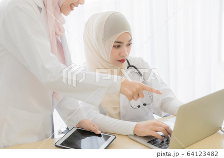 Woman doctor and muslim patient 64123482