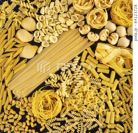 Italian pasta square background texture, a flat lay of many different pasta types, shot from the top on a black background 64123728
