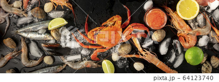 Seafood. Crab, mussels, shrimps, clams on ice, shot from the top on a black background Seafood. Crab, mussels, shrimps, clams on ice, shot from the top on a black background 64123740