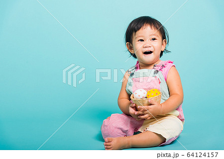 Cute little baby girl beautiful holding Easter egg 64124157
