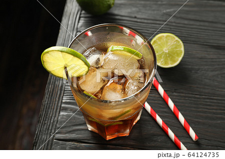 Glass of cold cola with citrus and ice on wooden 64124735