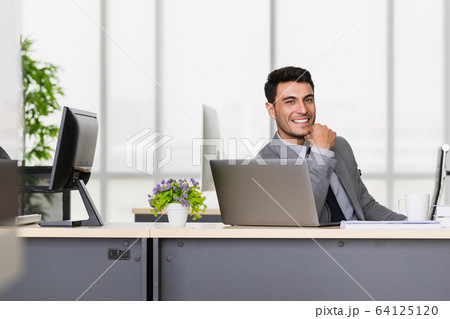 Businessman sitting and thump up in modern Businessman sitting and thump up in modern 64125120