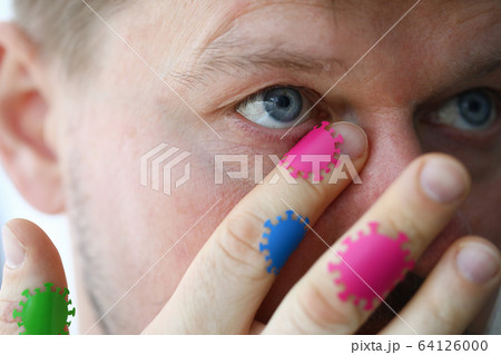 Middle-aged man touching mucous membranes 64126000