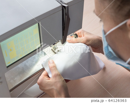 Stop Pandemia concept. Making protective masks. Stop Pandemia concept. Making protective masks. 64126363