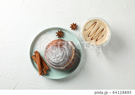 Tasty cinnamon roll with ingredients, cappuccino Tasty cinnamon roll with ingredients, cappuccino 64128895