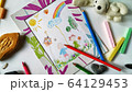 Children's color picture or drawing in a frame with colourful pencils, crayons and toys 64129453