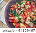 Clay plate with mix colourful vegetable soup or stew and crackers top view 64129467