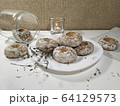 Iced homemade gingerbreads on a white plate in light pastel tones 64129573