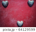 Red dusty background with heart shaped sweet biscuits and text space for valentine's day 64129599