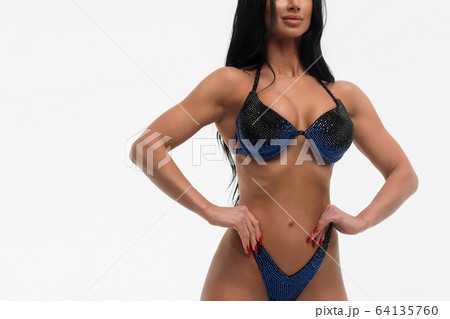 Sportswoman in blue bikini in studio Sportswoman in blue bikini in studio 64135760