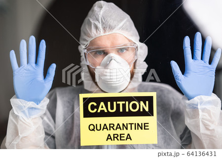 Man in protective white overalls, mask and glasses on his face. Coronavirus, pandemic, covid-19, flu and quarantine concept. Man in protective white overalls, mask and glasses on his face. Coronavirus, pandemic, covid-19, flu and quarantine concept. 64136431