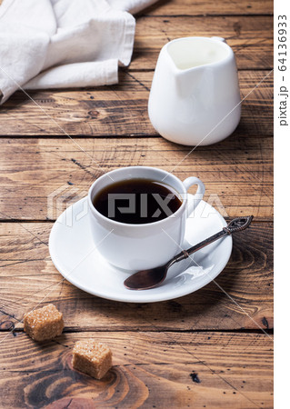 Cup of black coffee and milk on a wooden 64136933