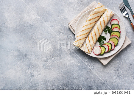 Roll with cheese and herbs. Grilled pita bread Roll with cheese and herbs. Grilled pita bread 64136941