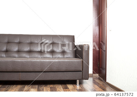 Brown leather sofa in room 64137572