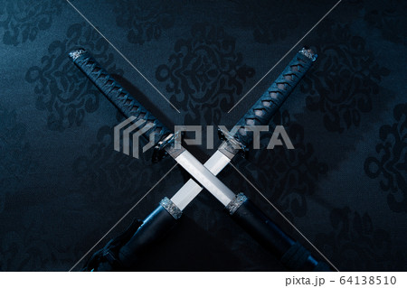 Two katanas with partially drawn blades on fabric Two katanas with partially drawn blades on fabric 64138510