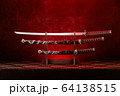 Three swords on stand, katana blade exposed, red 64138515
