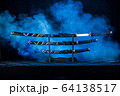 Three swords on stand, one blade partially visible 64138517