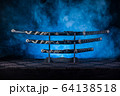 Three swords on stand, blue smoke behind 64138518