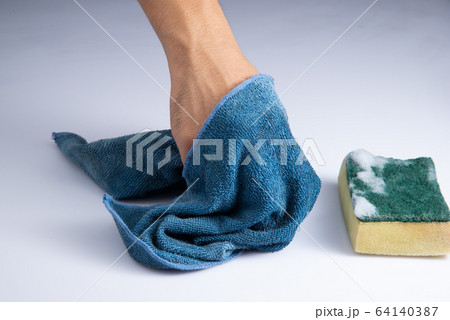 washing white acrylic sheet by bare hand and blue rag sponge foam on white background stock photo 64140387