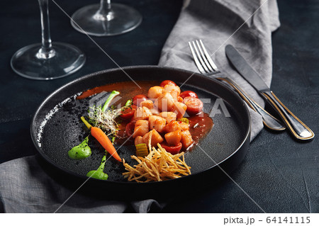Grilled scallops with vegetables and sauce, a beautiful presentation from the chef, food photo, dark background. copy space, seafood food concept Grilled scallops with vegetables and sauce, a beautiful presentation from the chef, food photo, dark background. copy space, seafood food concept 64141115
