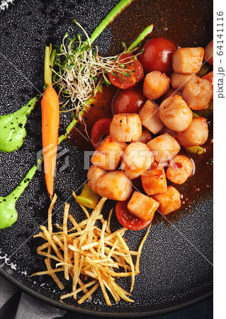 Grilled scallops with vegetables and sauce, a beautiful presentation from the chef, food photo, dark background. copy space, seafood food concept. Close-up, top view Grilled scallops with vegetables and sauce, a beautiful presentation from the chef, food photo, dark background. copy space, seafood food concept. Close-up, top view 64141116
