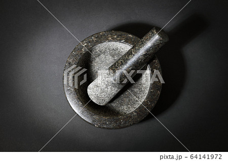 Top view of mortar and pestle on dark surface Top view of mortar and pestle on dark surface 64141972