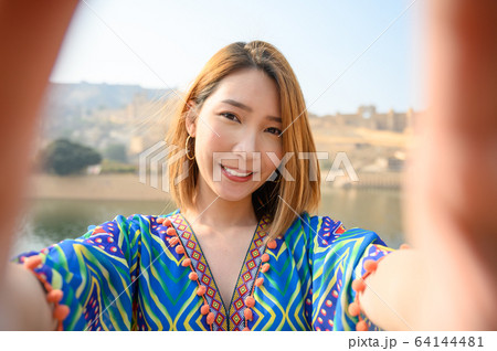 Young woman colorful dress selfie herself  Young woman colorful dress selfie herself  64144481