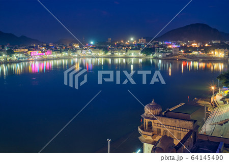 Night view of famous indian hinduism pilgrimage town sacred holy hindu religious city Pushkar with Pushkar ghats. Rajasthan, India. Horizontal pan Night view of famous indian hinduism pilgrimage town sacred holy hindu religious city Pushkar with Pushkar ghats. Rajasthan, India. Horizontal pan 64145490