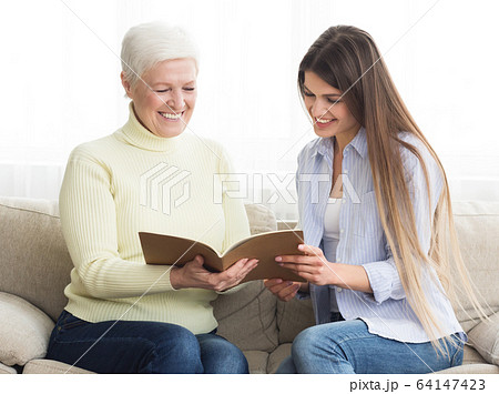 Financial consultant presenting bank investments to senior woman 64147423
