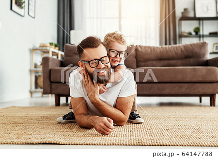 Father and little son having fun at home 64147788