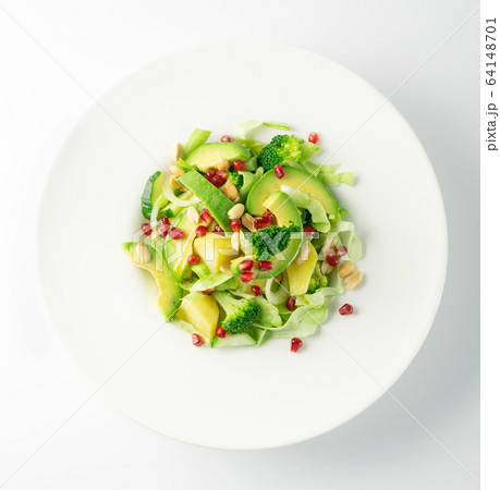 Green Salad with Avocado, Cucumber and Nuts on 64148701