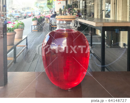 A large red transparent glass round luminous  64148727