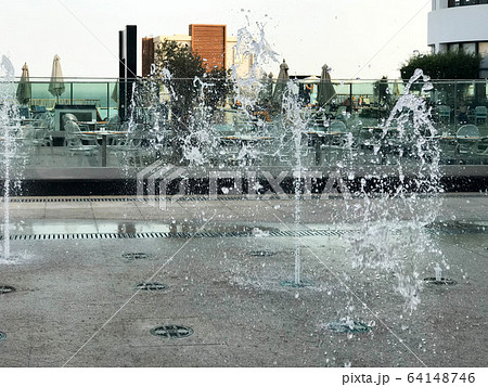 A small singing fountain in the open air, on  64148746