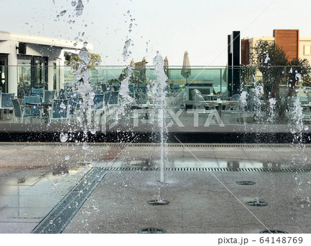 A small beautiful singing fountain in the open A small beautiful singing fountain in the open 64148769