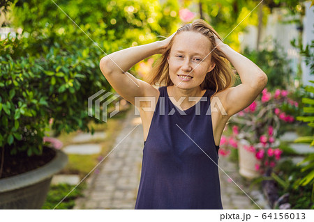 I love my skin. A young woman with freckles, moles, scars and facial wrinkles loves her skin, enjoys 64156013