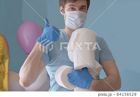 Funny man holding many rolls of toilet paper Funny man holding many rolls of toilet paper 64156529