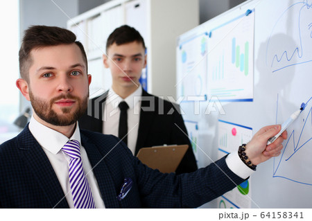 Smiling handsome bearded caucasian man in office telling something important 64158341