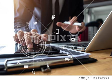 Business man using digital tablet analyzes business data, busy working on laptop computer with smart phone and business report on office desk, business strategy analysis concept. Business man using digital tablet analyzes business data, busy working on laptop computer with smart phone and business report on office desk, business strategy analysis concept. 64158954