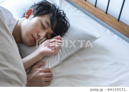 若い男性の寝顔の写真素材