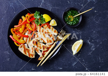 Grilled chicken tenders with peppers, top view Grilled chicken tenders with peppers, top view 64161141