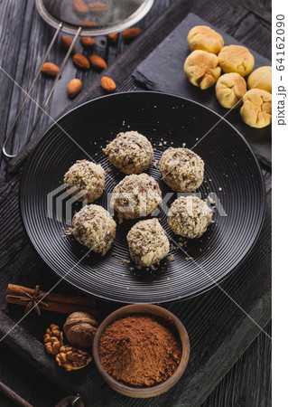 Delicious homemade chocolate chip cookies balls on a black wooden background. Delicious homemade chocolate chip cookies balls on a black wooden background. 64162090