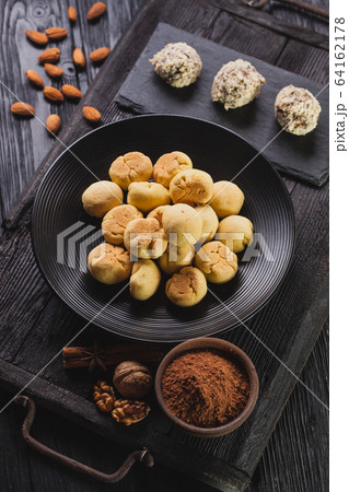 Delicious homemade chocolate chip cookies balls on a black wooden background. 64162178