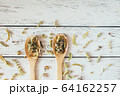 Natural organic herbal green tea in wooden spoons. 64162257