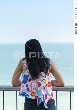 Woman relax at sea viewpoint in concept travel Woman relax at sea viewpoint in concept travel 64163125