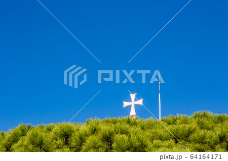 Porto Lagos church cross view against blue sky 64164171